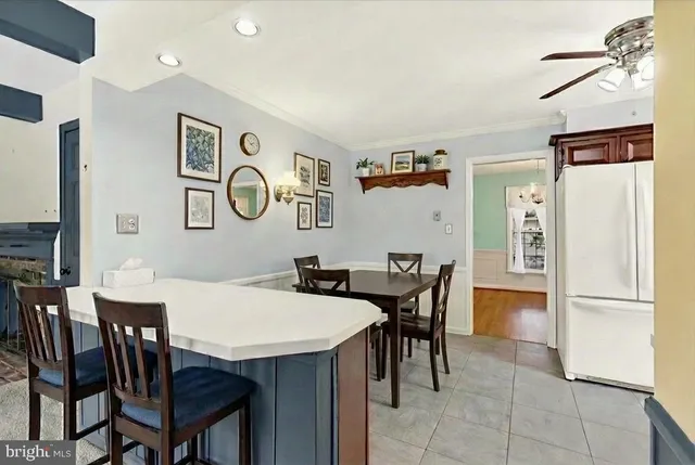 a view of a dining room with furniture a chandelier and wooden floor