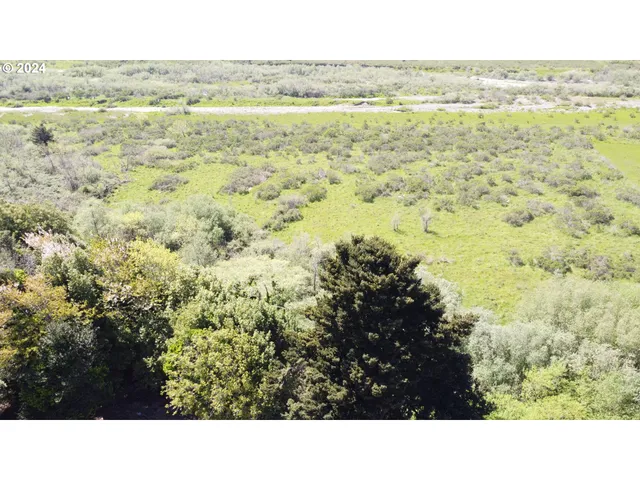 an empty room with wooden floor and a window
