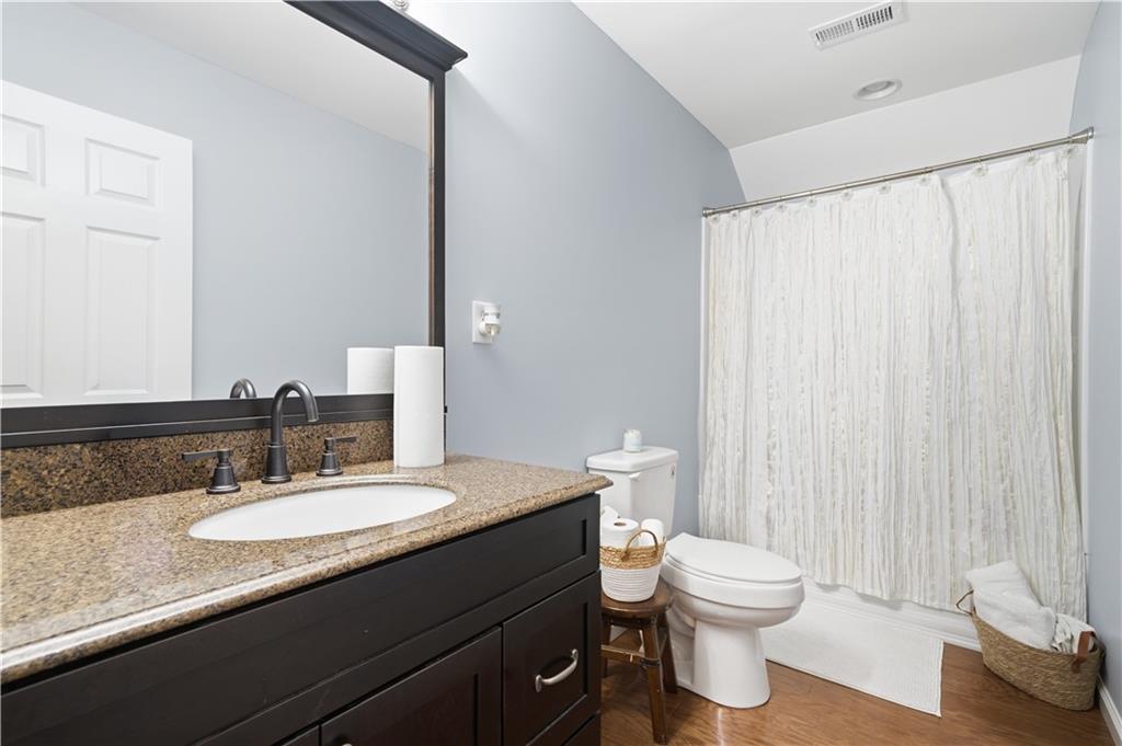 310 Gaines Road Southeast Dalton, GA 30721 - Photo 35 of 53 a bathroom with a granite countertop sink a toilet and a mirror