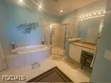a bathroom with a granite countertop sink a toilet and shower