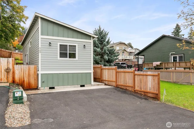 a view of a house with backyard and sitting area