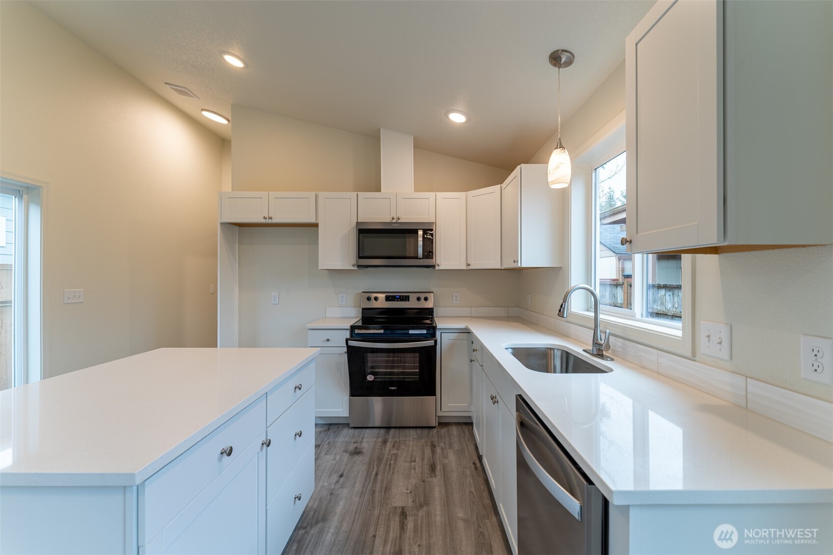 569 North 3rd Kalama, WA 98625 - Photo 9 of 22 a kitchen with granite countertop white cabinets and stainless steel appliances