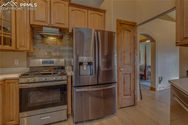 a kitchen with a stove and a refrigerator