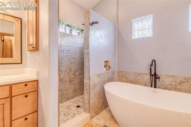 a bathroom with a bathtub and a shower