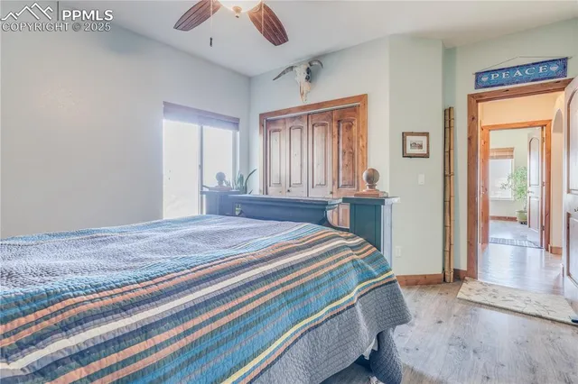 a bedroom with a bed and large windows