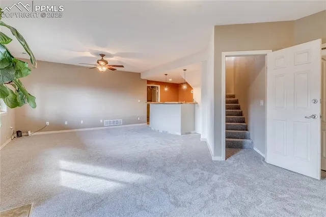 an empty room with windows and cabinet