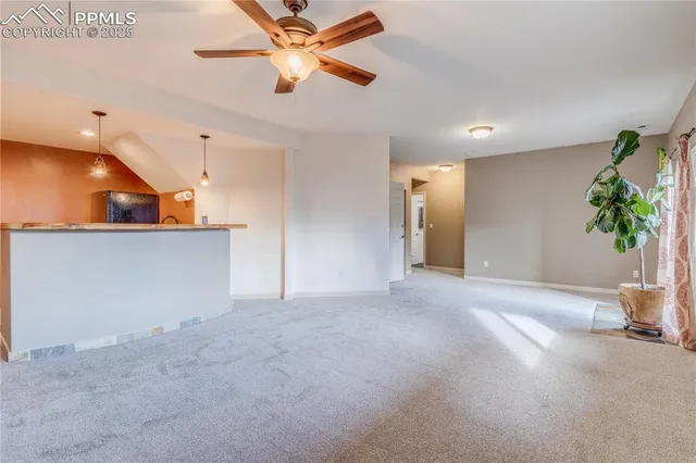 a view of a kitchen with a sink and a chandelier fan