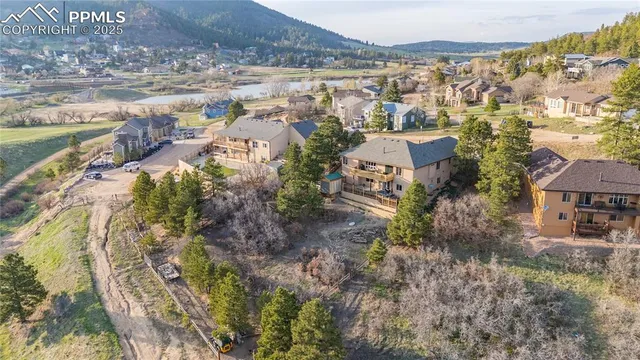 a view of residential houses with outdoor space and trees