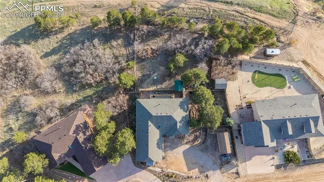 an aerial view of a house with a yard