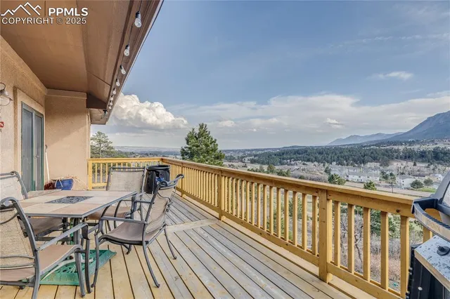 a view of a balcony with chairs and wooden floor