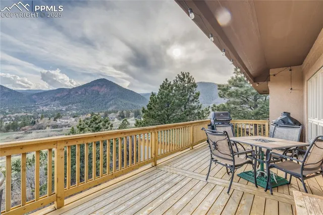 a view of a chairs and table on the balcony