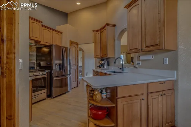 a kitchen with stainless steel appliances a sink cabinets and a counter top space