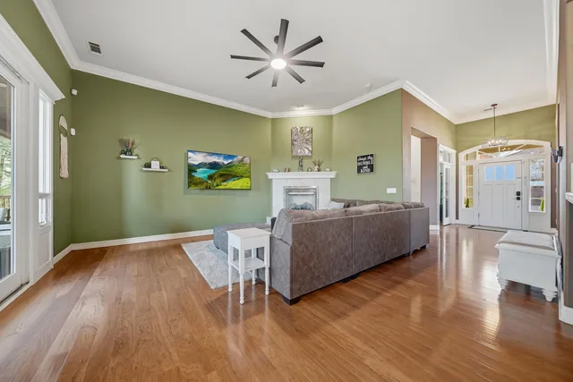 a living room with furniture and a wooden floor