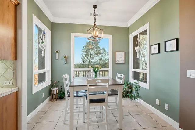 a dining room with a table and chairs