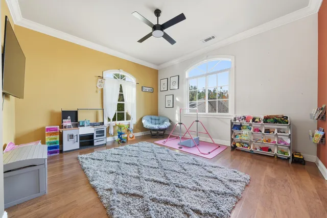 a bedroom with furniture and a wooden floor