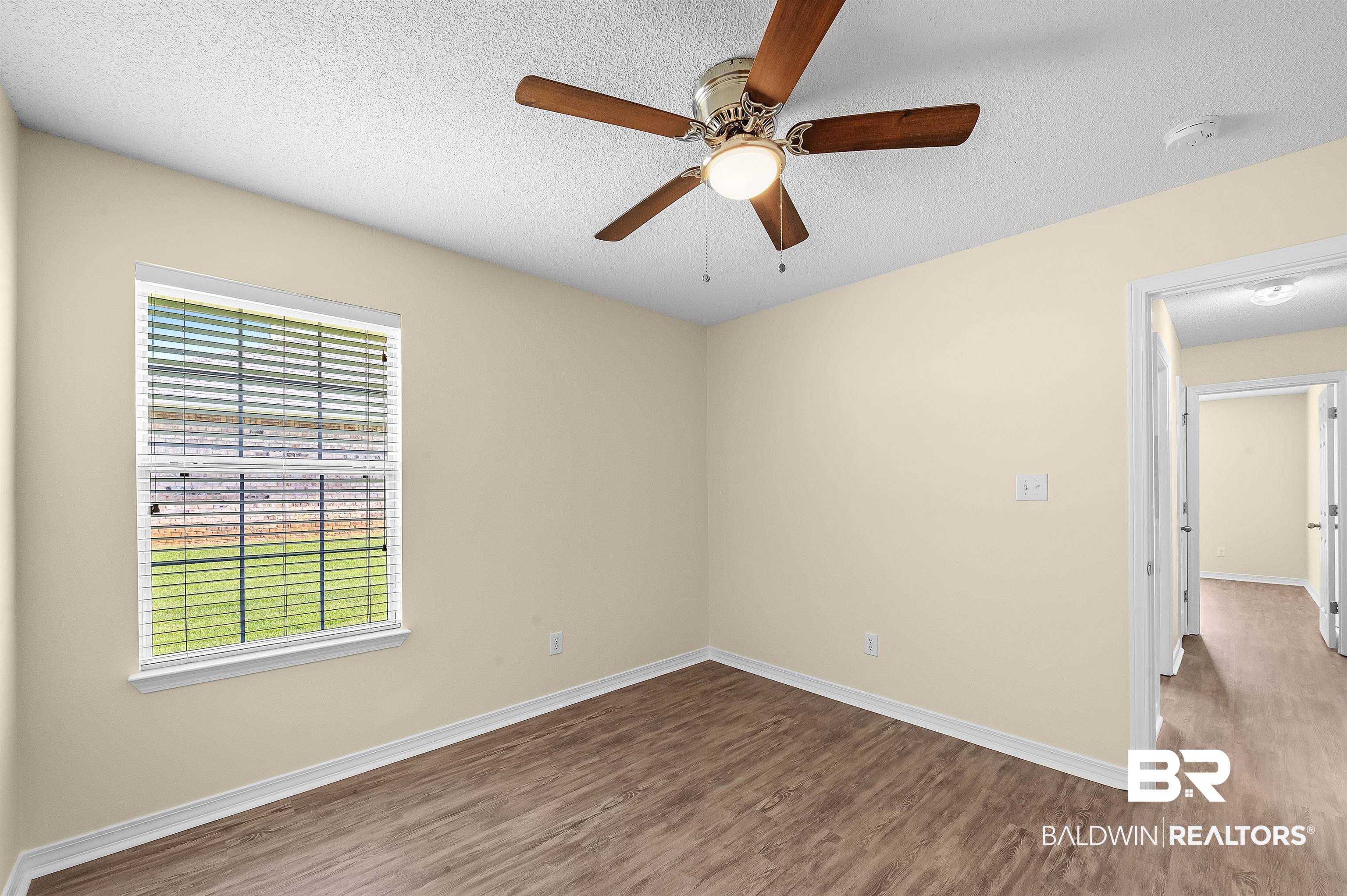 12443 Venice Boulevard Foley, AL 36535 - Photo 55 of 59 Unfurnished room featuring hardwood / wood-style floors, ceiling fan, and a textured ceiling