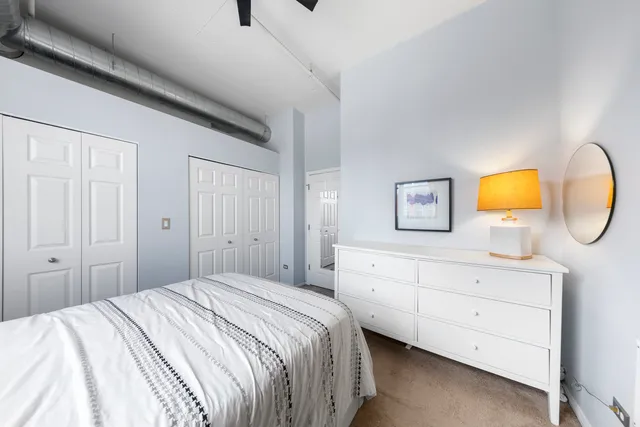 a bedroom with a bed and a dresser