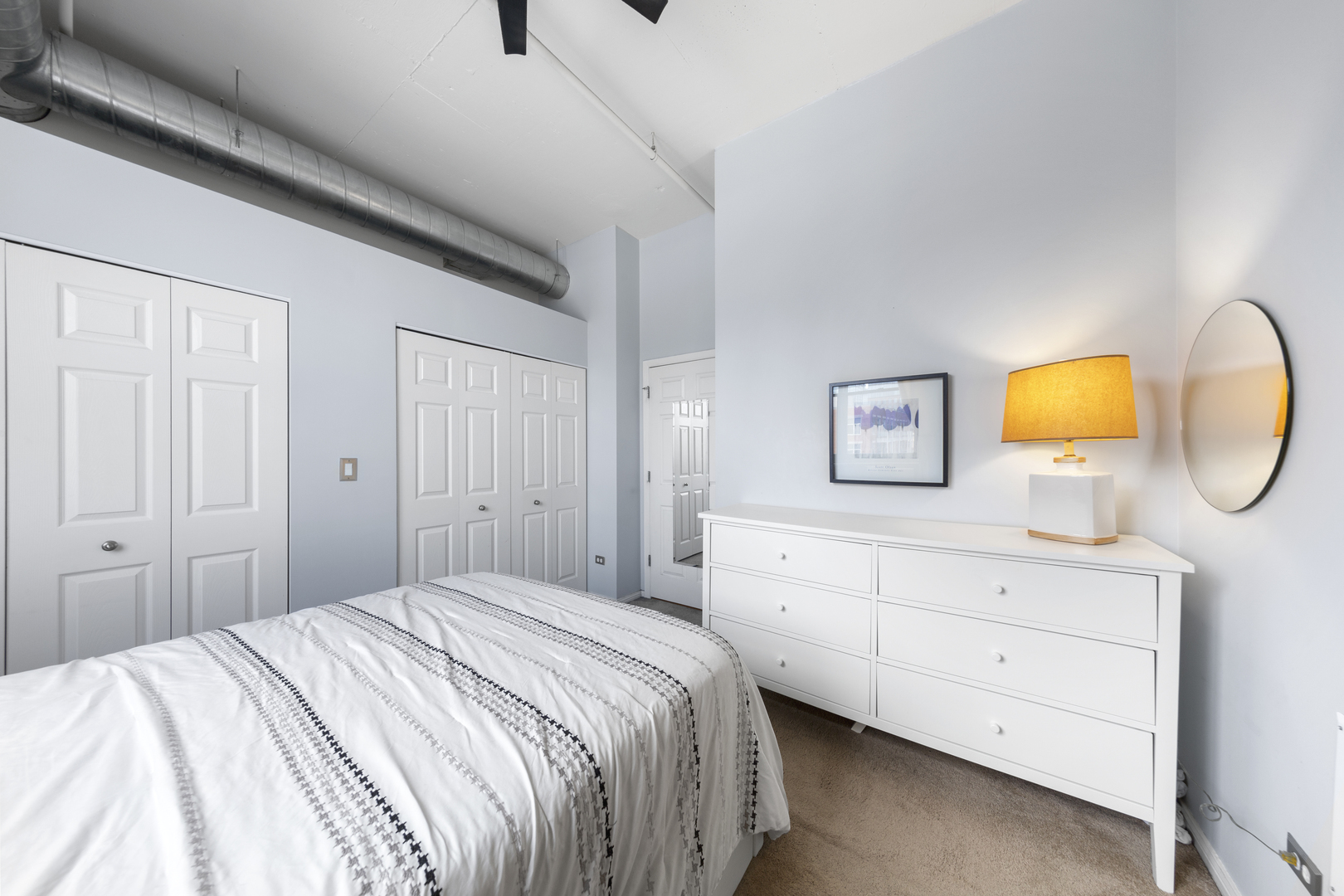 950 West Monroe Street, Unit 616 Chicago, IL 60607 - Photo 13 of 28 a bedroom with a bed and a dresser