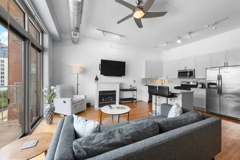 a living room with furniture a fireplace and a flat screen tv