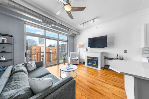 a living room with fireplace furniture and a flat screen tv