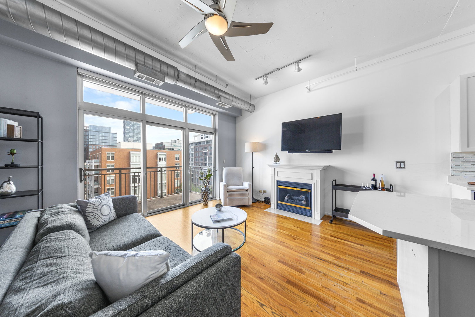 950 West Monroe Street, Unit 616 Chicago, IL 60607 - Photo 6 of 28 a living room with fireplace furniture and a flat screen tv