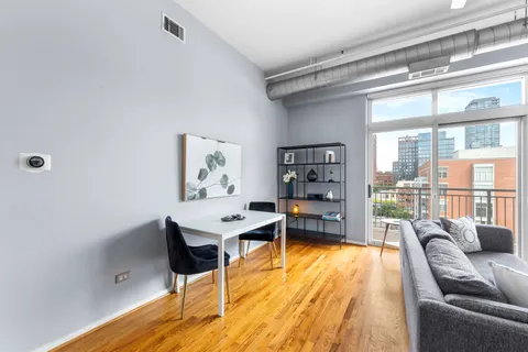 a living room with furniture and a book shelf