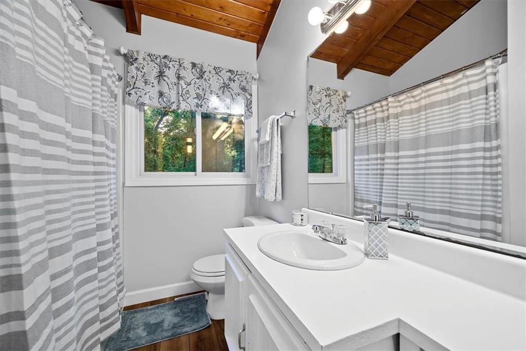 228 Foxglove Road Baden, PA 15005 - Photo 16 of 25 a bathroom with a sink a toilet and shower curtain