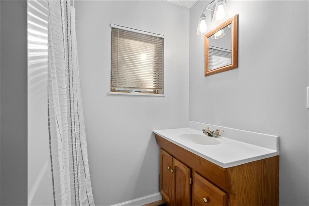 228 Foxglove Road Baden, PA 15005 - Photo 21 of 25 a bathroom with a sink and a mirror