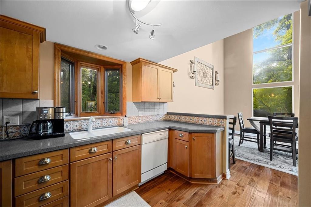 228 Foxglove Road Baden, PA 15005 - Photo 9 of 25 a kitchen with stainless steel appliances granite countertop wooden cabinets a stove a sink and a large window