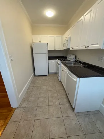 a kitchen with a sink a stove and refrigerator