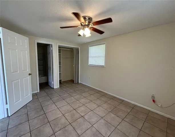 a view of a livingroom with a ceiling fan and window