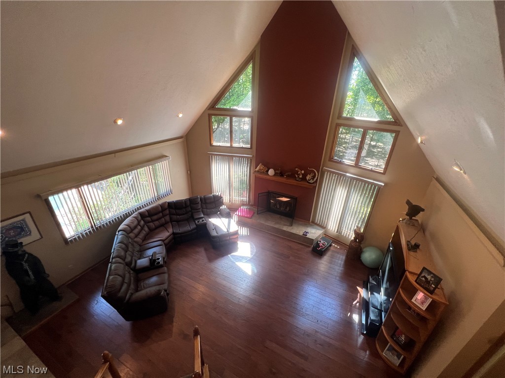 7129 State Rte 5 Ravenna, OH 44266 - Photo 14 of 28 Living room with plenty of natural light, lofted ceiling, a fireplace, dark hardwood floors, and a high ceiling