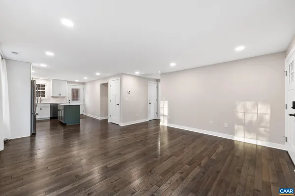 a view of kitchen with refrigerator and window