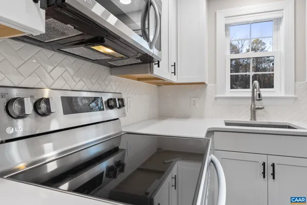 a kitchen with a refrigerator stove and sink