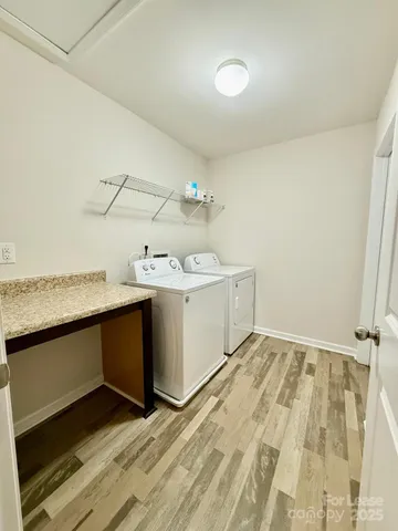 an empty room with windows and ceiling fan