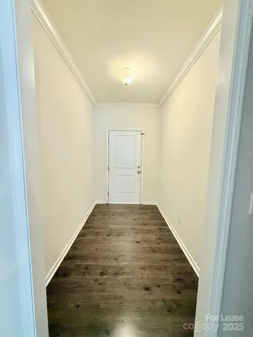 a kitchen with stainless steel appliances granite countertop a stove a sink dishwasher a refrigerator and white cabinets with wooden floor