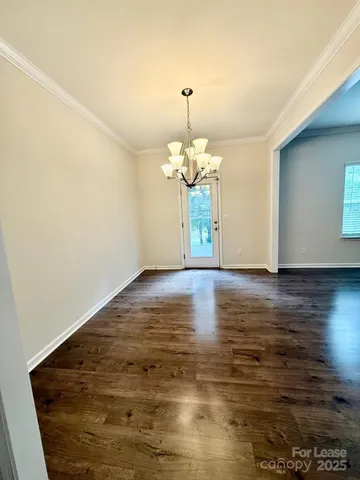 a white toilet sitting next to a white wall