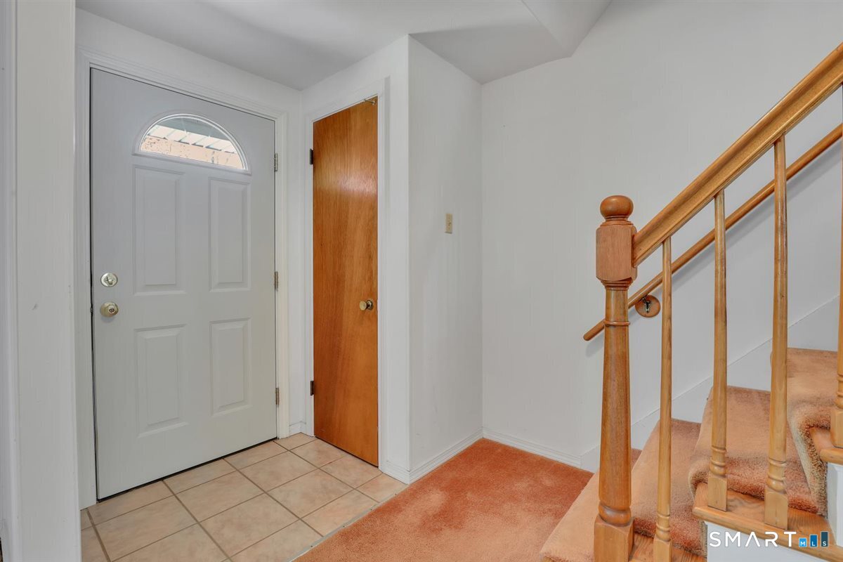 40 Wappingwood Road Ellington, CT 06029 - Photo 14 of 31 The main entryway offers additional storage and brings in even more natural light to this light-filled home.