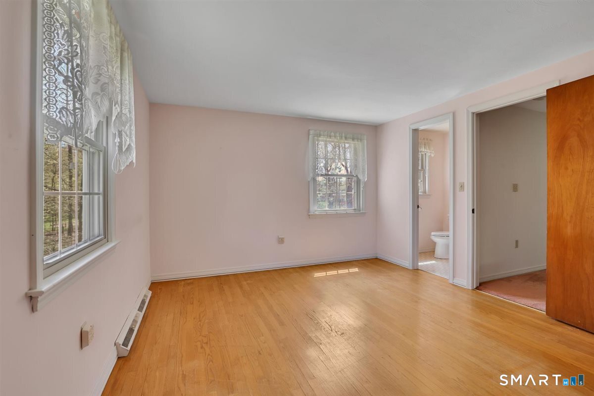 40 Wappingwood Road Ellington, CT 06029 - Photo 16 of 31 The primary bedroom features hardwood floors and its own private half bath.