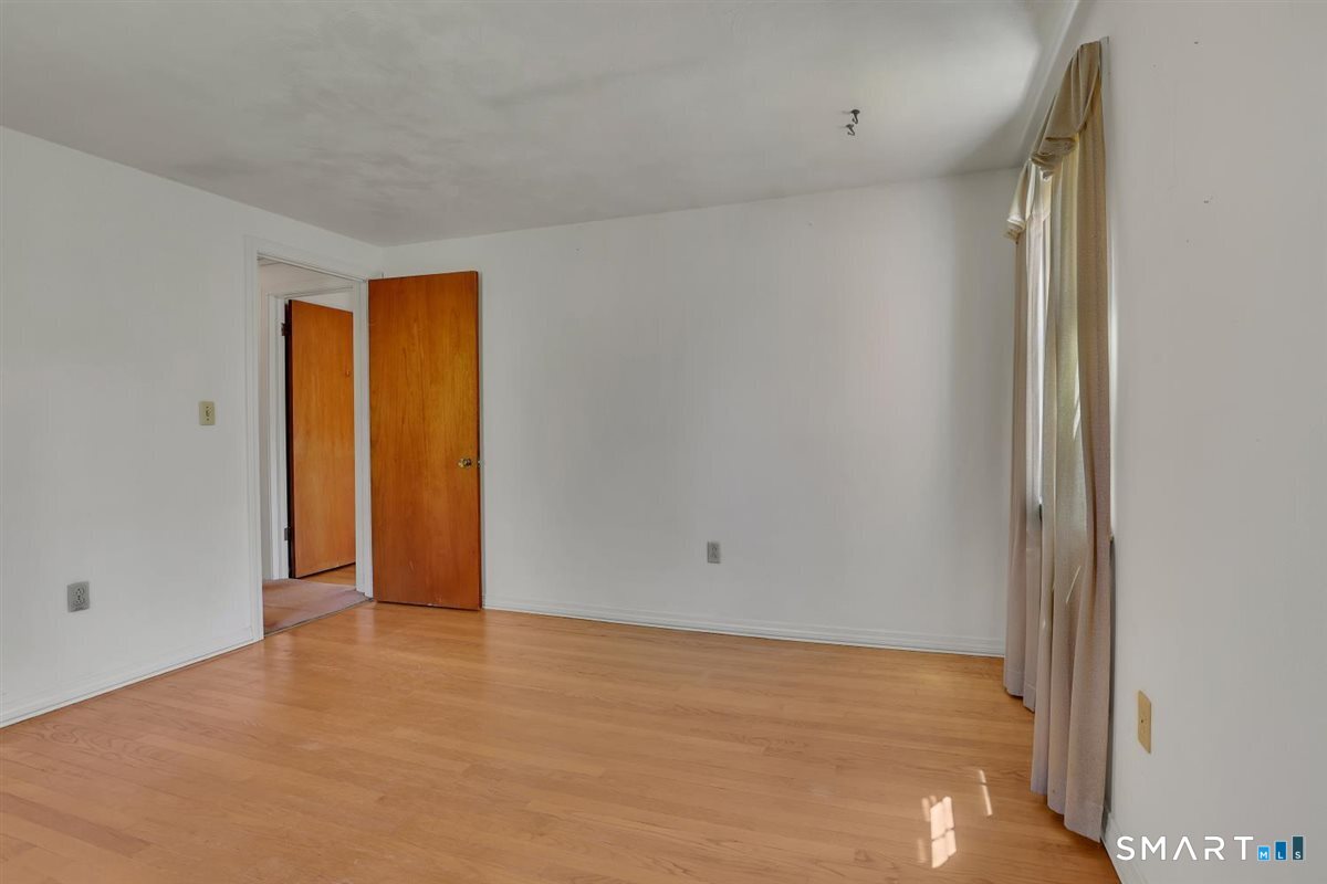 40 Wappingwood Road Ellington, CT 06029 - Photo 22 of 31 The third bedroom is located straight down the hall and features hardwood floors and ample storage.
