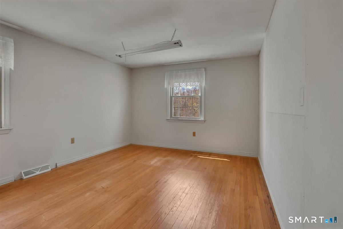 40 Wappingwood Road Ellington, CT 06029 - Photo 25 of 31 Like the other bedrooms, this room features hardwood floors, ample storage, and natural light.