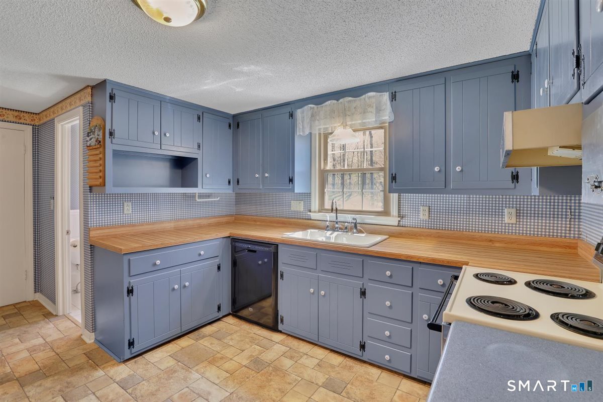 40 Wappingwood Road Ellington, CT 06029 - Photo 3 of 31 The heart of the home is a charming cottage-style kitchen with a half bath conviently located to the left.