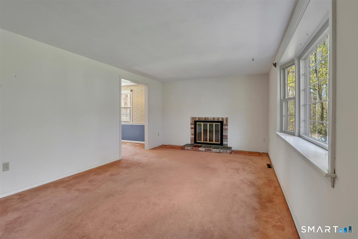 40 Wappingwood Road Ellington, CT 06029 - Photo 10 of 31 This inviting living room offers plenty of space to spread out and relax.