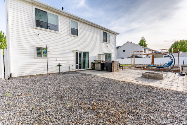 1652 West 800 South Lehi, UT 84043 - Photo 26 of 27 Back of property with an outdoor fire pit, a patio, and a fenced backyard