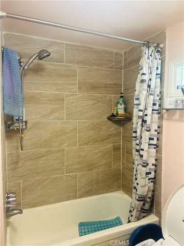 a bathroom with a bathtub and shower