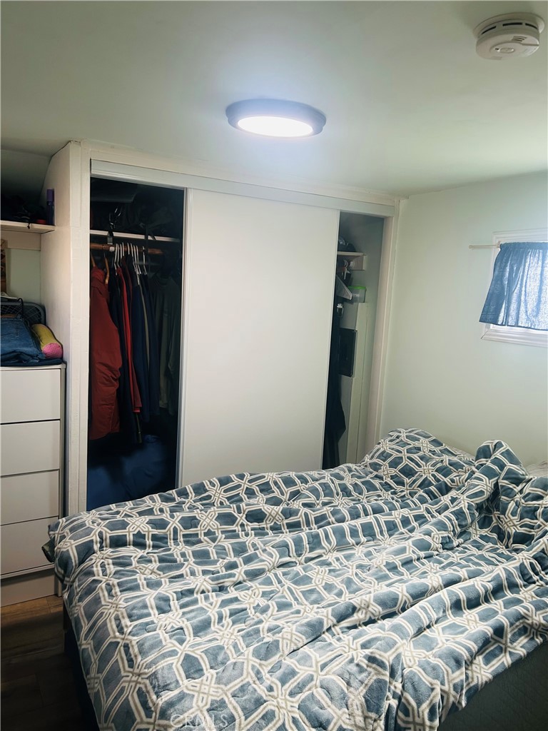 1436 West 130th Street Gardena, CA 90249 - Photo 9 of 13 a bedroom with a bed and a walk in closet