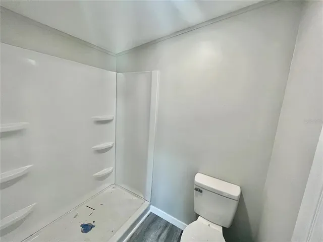 a bathroom with a toilet and shower