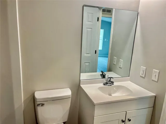 a bathroom with a sink a toilet and mirror