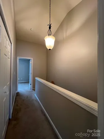 a view of small space with a chandelier fan