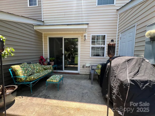 a view of a patio with chair and tables